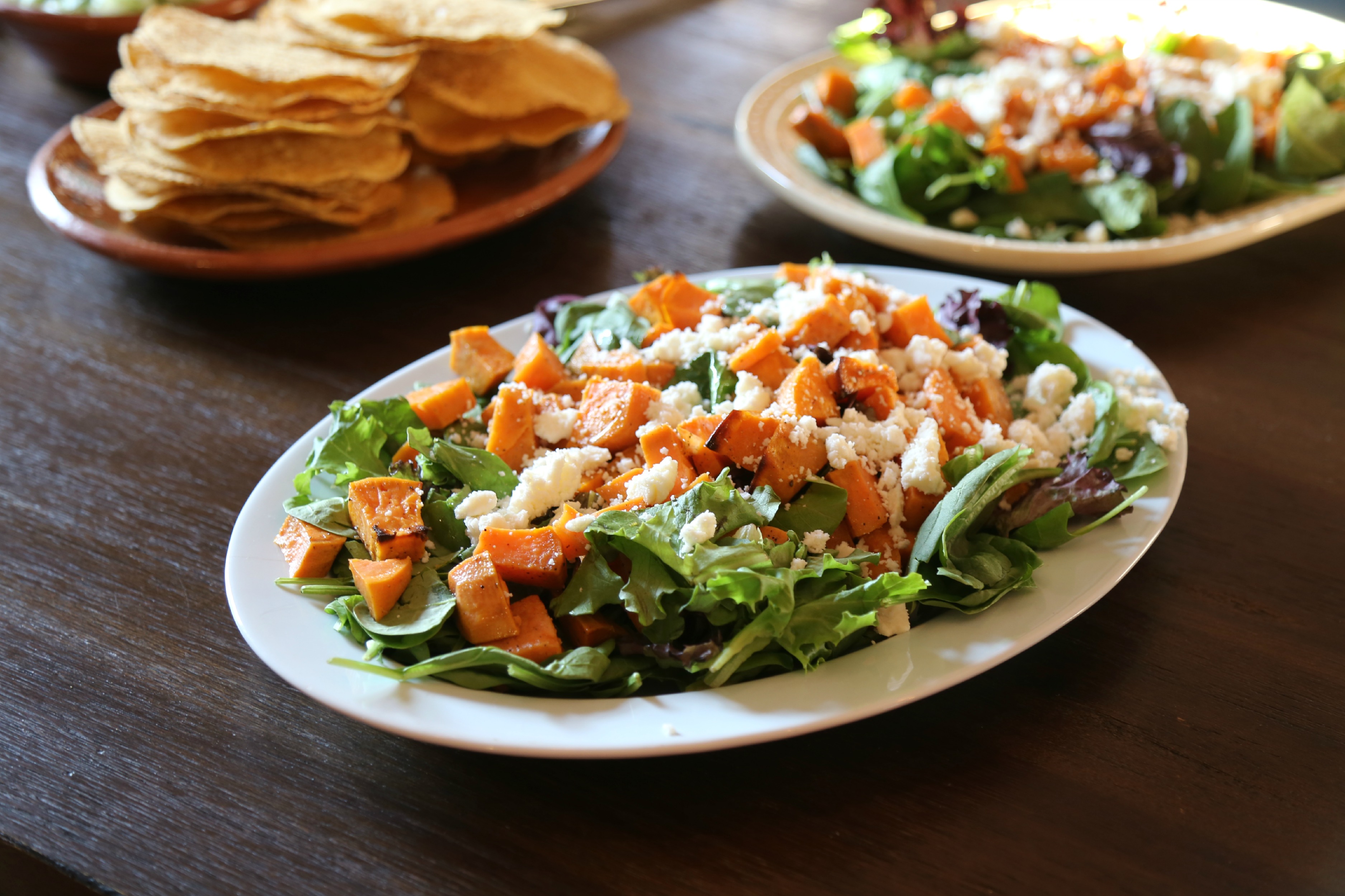 Roasted Sweet-Potato Salad with Hibiscus Lime Dressing - a fall inspired salad made with roasted sweet potatoes served over a bed of mixed greens, topped with queso fresco, pepitas and dressed with hibiscus-lime vinaigrette.