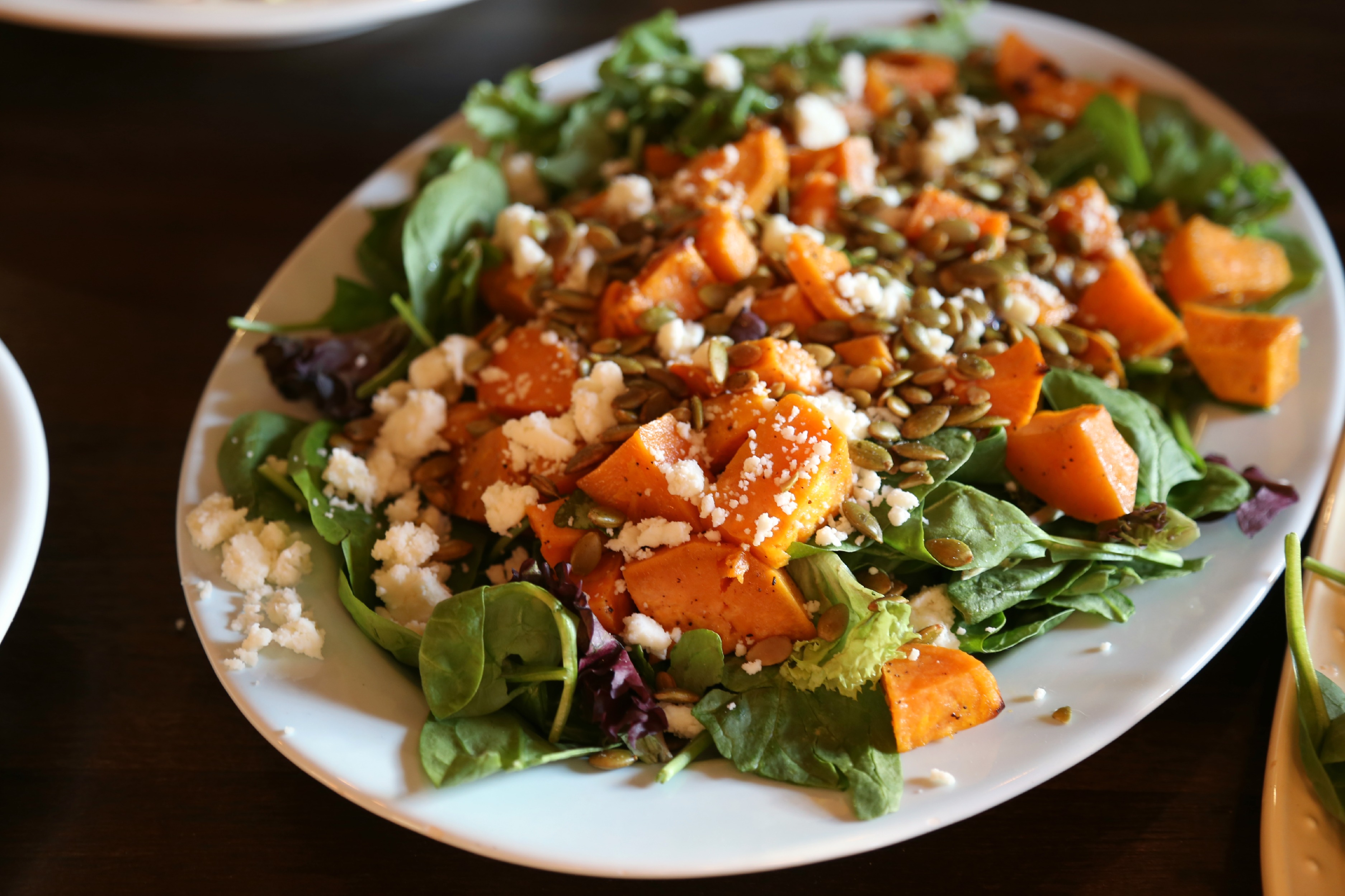 Roasted Sweet-Potato Salad with Hibiscus Lime Dressing - a fall inspired salad made with roasted sweet potatoes served over a bed of mixed greens, topped with queso fresco, pepitas and dressed with hibiscus-lime vinaigrette. 
