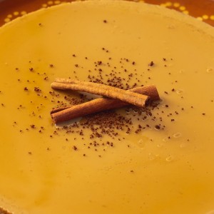 Cappuccino Flan served with cinnamon sticks on top