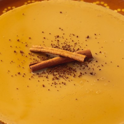 Cappuccino Flan served with cinnamon sticks on top